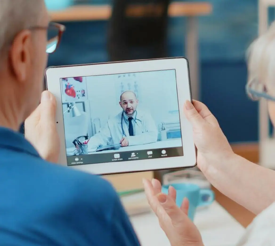 This is an image of two elderly patients on a virtual call with their GP